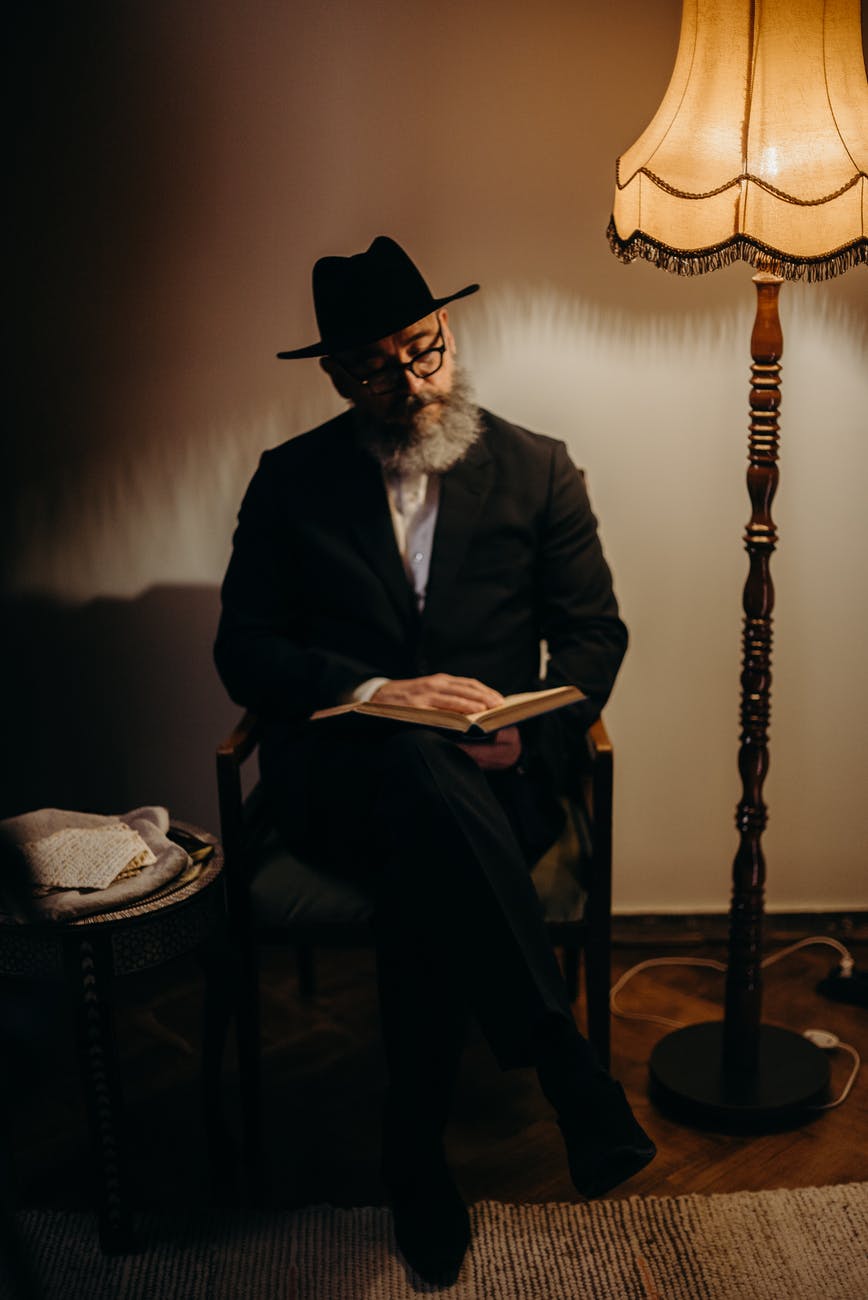 man sitting lamp book